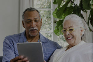 An older couple looking at a tablet