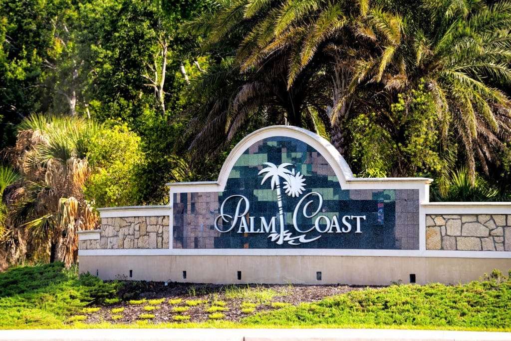 A sign for Palm Coast in Florida where We Buy Houses For Cash In Palm Coast