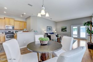 A staged listed house with white walls, white chairs, and light wooden cabinets listed on the NEFMLS by Wholesale Realty LLC.